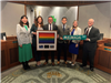 Councilmember Shawn Kumagai, holding a Pride flag, with Dublin City Council on his last day at the C