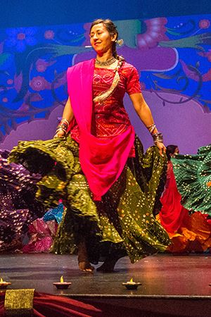 female dancer from Colors of India in a pink and green dress