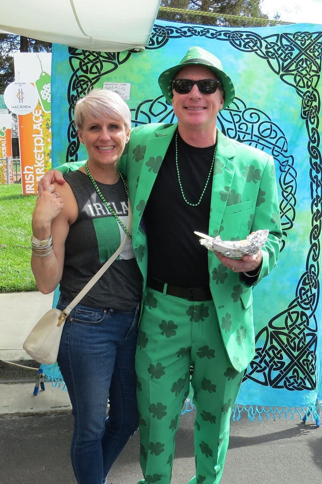 Happy shoppers with green suit