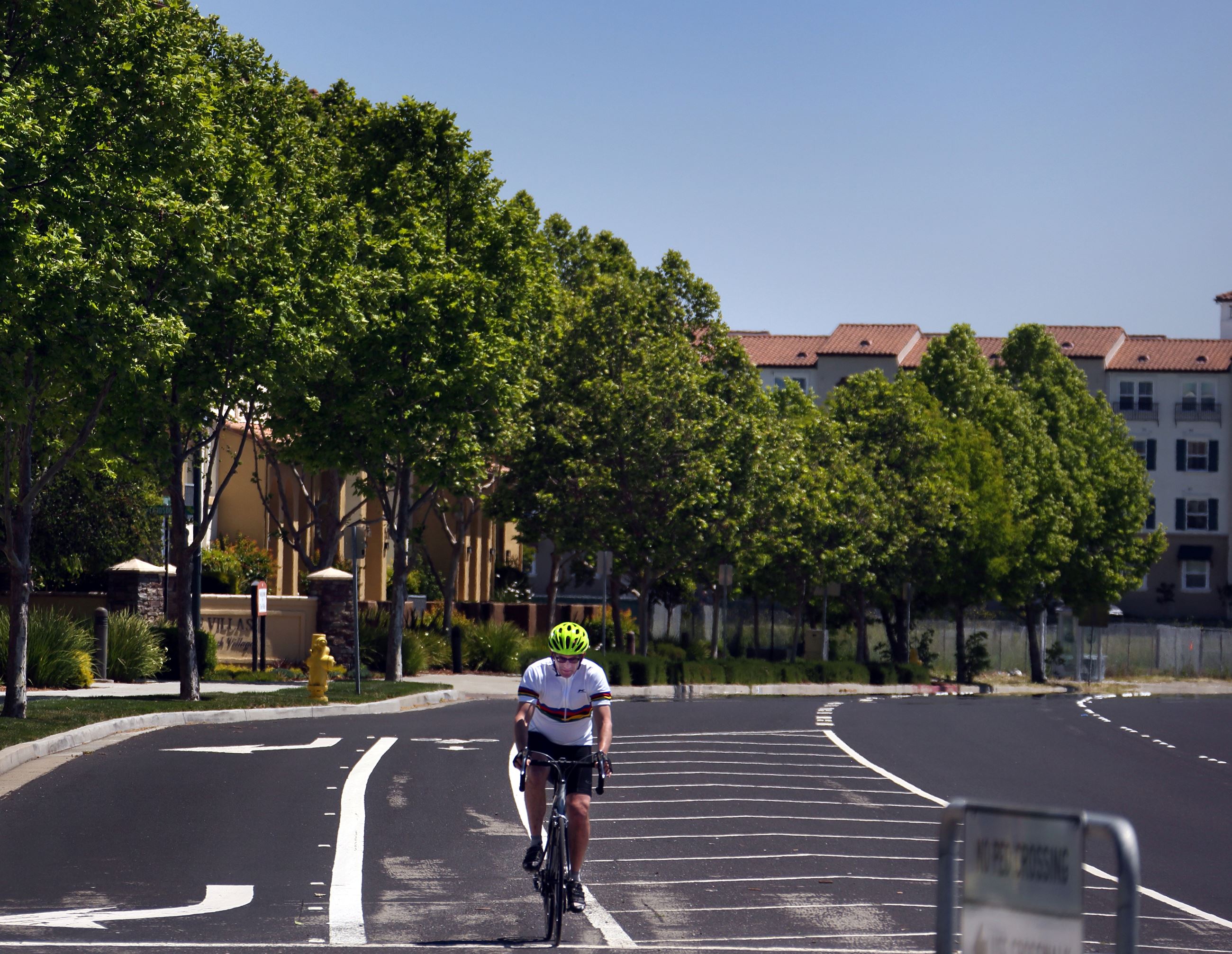 bicyclist riding his bike in the bike lane on a city street