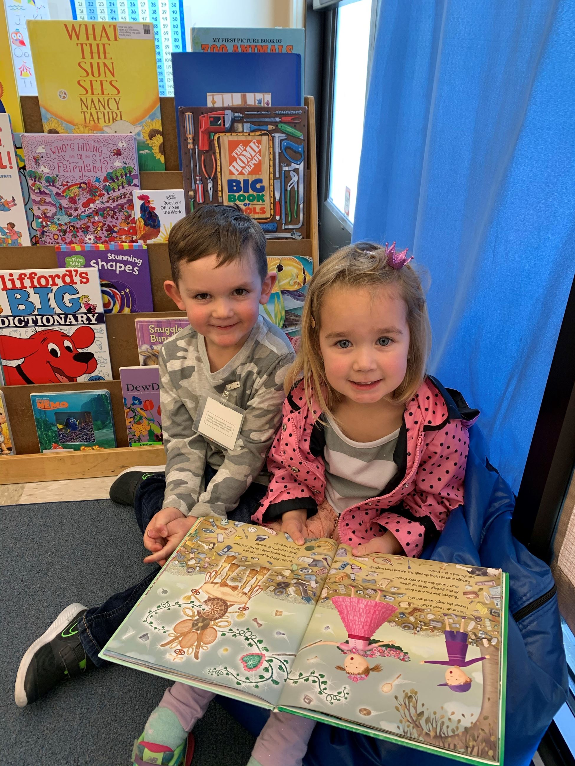 Preschool boy and girl reading book