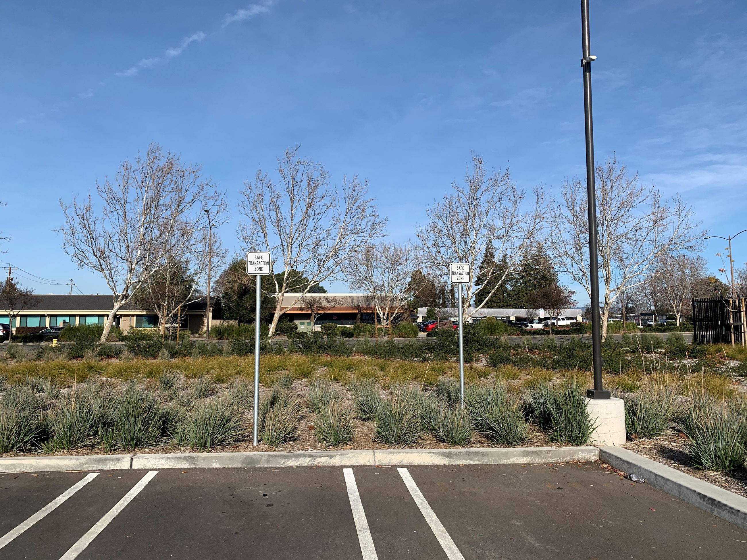 Two Safe Transaction Zone signs in the parking lot at Dublin Police Services.