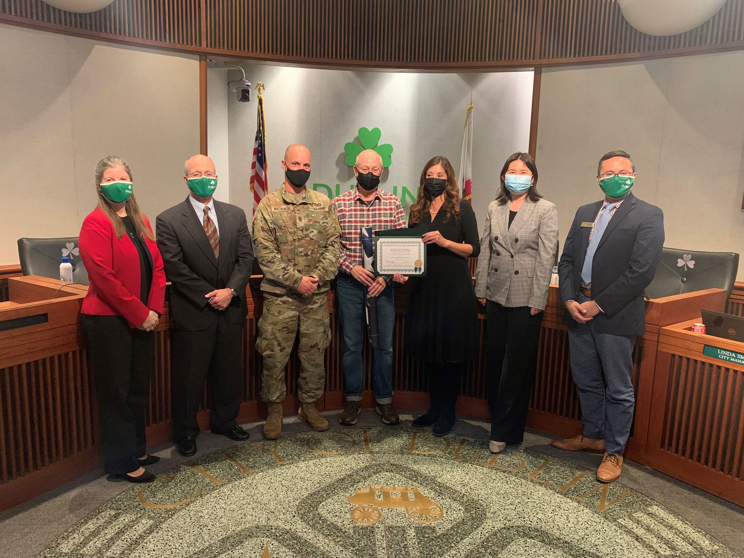 Steve Minniear Accepts a Military Banner in Honor of Retired Rear Admiral Charles Wellman Parks, U.S
